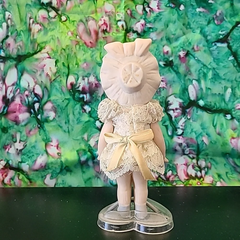Vintage porcelain doll w/stand